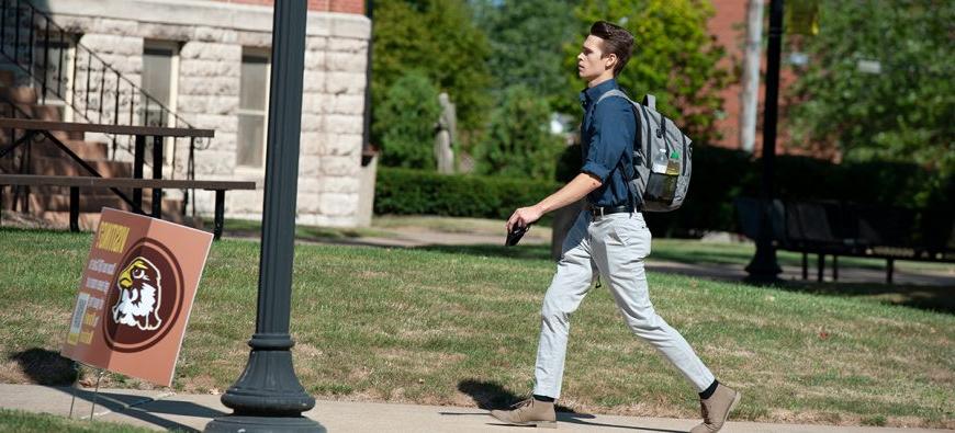 Student walking by Francis Hall